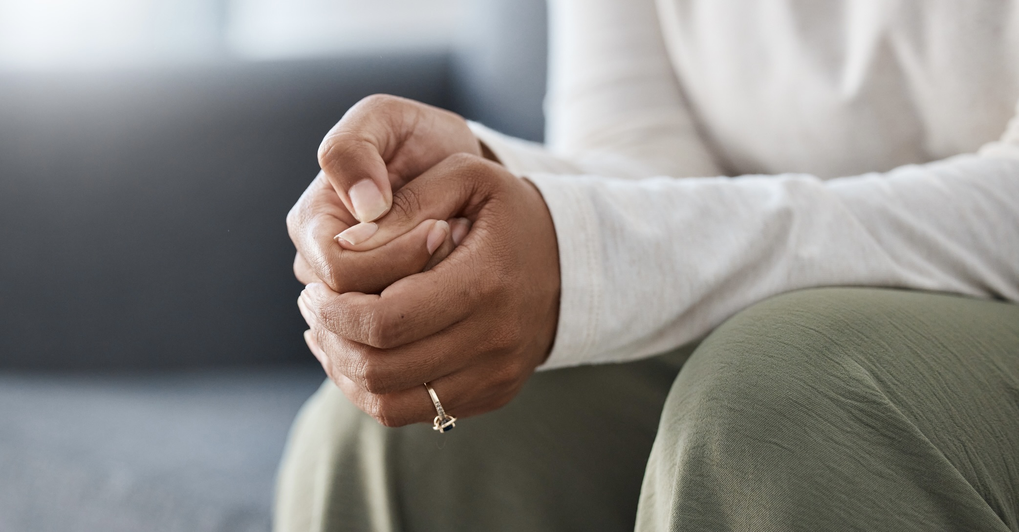 Anxious woman with hands folded together