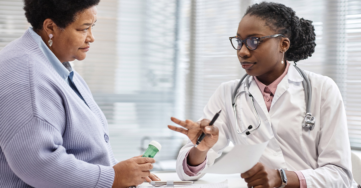 Doctor speaking to patient about medication treatment.